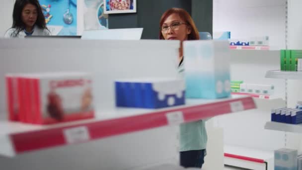 Asian Customer Putting Boxes Medication Drugstore Basket Looking Pills Package — Αρχείο Βίντεο