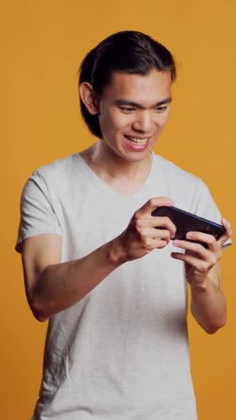 Vertical Video Happy Male Model Playing Video Games Smartphone Using — 비디오