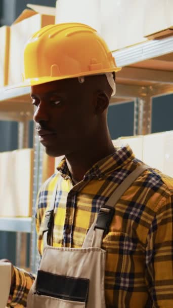 Vertical Video African American Man Posing Next Boxes Racks Working — Stockvideo