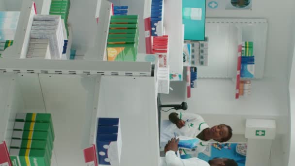 Vertical Video African American Pharmacist Putting Medication Racks Drugstore Arranging — Vídeo de Stock