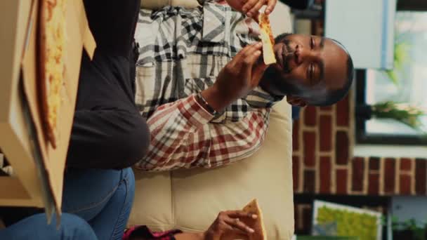 Vertical Video African American Partners Eating Pizza Slices Home Feeling — Vídeo de stock