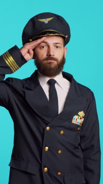 Vertical Video Young Pilot Showing Military Salute Studio Expressing Respect — Vídeo de Stock