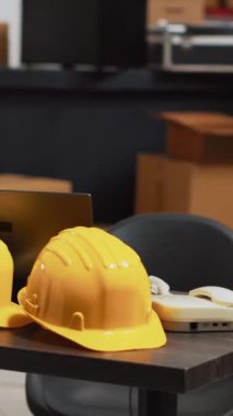 Vertical video: Small business depot filled with multiple products, empty storage room with cardboard boxes on racks. Stock merchandise placed on shelves in warehouse space, supply chain management.