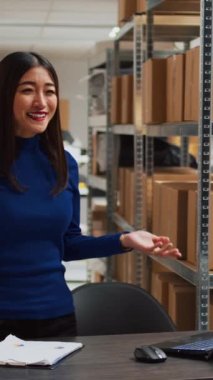 Vertical video: Business owner working on digital marketing with video, filming vlog for social media marketplace. Female entrepreneur making ad promotion campaign for development, teleshopping