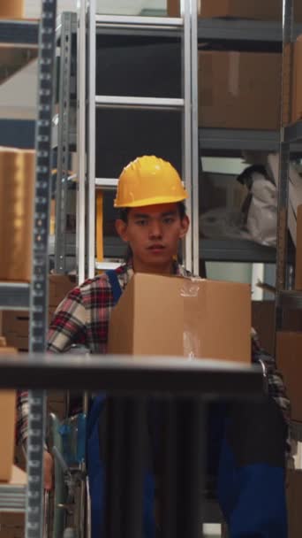Vertical Video Asian Man Wheelchair Moving Products Warehouse Checking Merchandise — Stockvideo