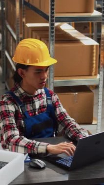 Vertical video: Young person planning distribution of orders in depot, working with woman to send retail store packages for supply chain. Team of employees checking merchandise and products, business