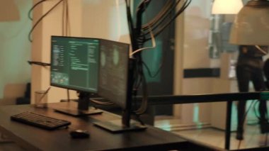 Group of thieves working with dark web to do illegal phishing on online network, trying to steal information illegally. Team of hackers breaking into server for cyberwarfare. Handheld shot.