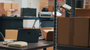 Warehouse filled with storage and merchandise boxes used for inventory and quality control, shipping products. Empty storehouse serving as small business space, delivery logistics.