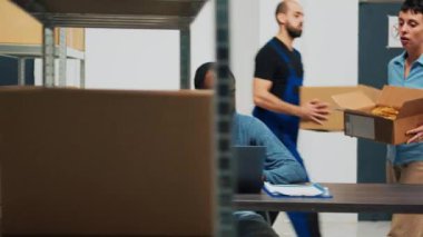 Business owners doing quality control on products from warehouse, checking cardboard packages of merchandise. Young entrepreneurs preparing goods in boxes, shipping distribution orders.