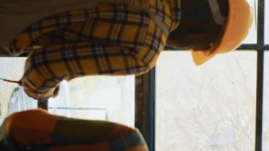 Vertical video: Two male employees working on logistics in depot with scanner and digital tablet, scanning shipment cargo with barcodes on shelves. People doing inventory with warehouse boxes. Tripod