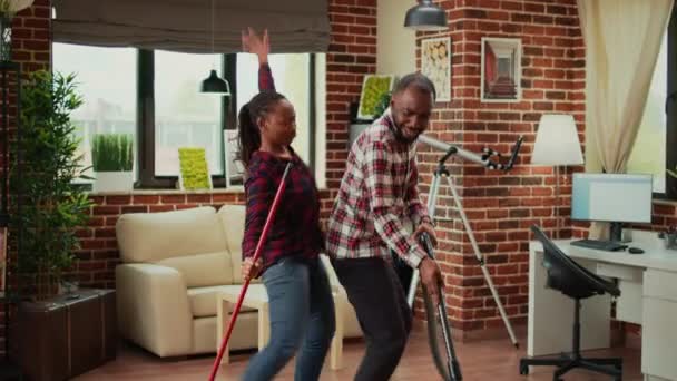 People African Ethnicity Being Funny Cleaning Living Room Using Mop — Stok video