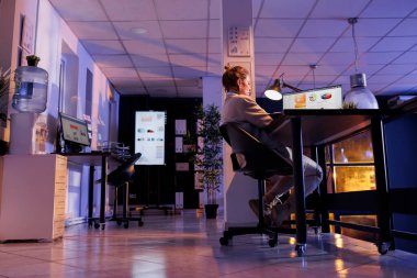 Businesswoman sitting at desk table in startup office, analyzing financial growth report planning company investment strategy to increase profit. entrepreneur working overtime at research plan