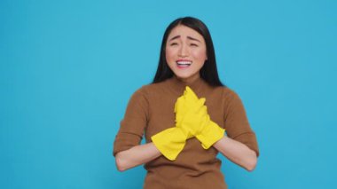 Happy professional maid being happy about finishing home cleaning while enjoying appreciation from her clients. Homekepper doing wonderful job, making sure every inch of the house was spotless.