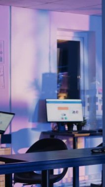 Vertical video: Professional manager checking diagrams on screen planning investment for business profit growth. Female entrepreneur analyzing data graphs on laptop, working after hours. Handheld shot