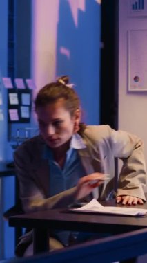Vertical video: Exhausted manager working overtime on research plan, yawning while trying to increase business profit. Professional advisor planning corporate investment for company growth, falling