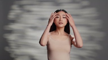 Natural beauty model with bare skin posing on camera, feeling flawless with imperfections and skincare products. Sensual woman enjoying empowering self love campaign, glowing appearance.