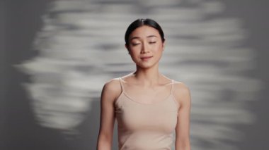 Sensual glowing adult creating empowering campaign to promote skincare products and beauty routine. Happy confident woman with radiant luminous skin, posing with glamour on camera.