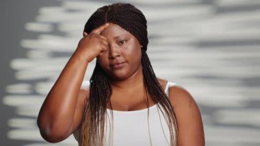 Positive girl with natural radiant skin posing in studio, creating skincare ad for body positivity. Young cheerful beauty model advertising self love acting confident and empowering.