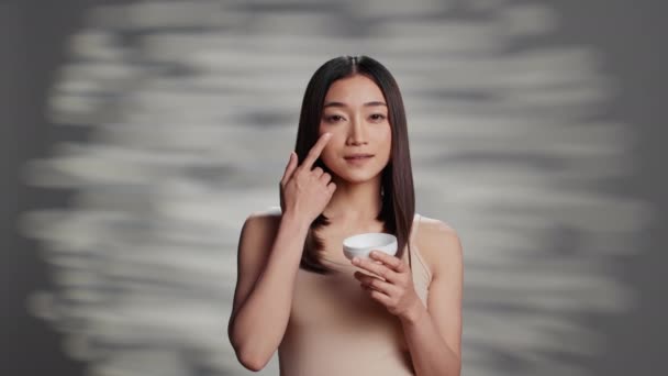 Young Radiant Person Applying Moisturizing Cream Promote Skincare Routine Uplifting — Stock Video