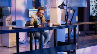 Female employee analyzing documents with diagrams in business office, working with papers to create official financial report. Manager planning economy project to increase company profit.