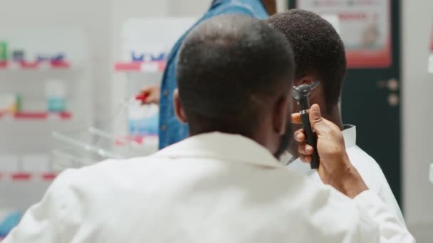 Pharmacy Worker Consulting Man Otoscope Tool Otologist Doing Consultation Ear — Vídeos de Stock