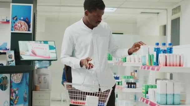 Male Customer Taking Vitamins Box Drugstore Shelves Looking Pharmaceutical Products — Stockvideo