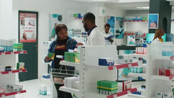 Caducidad Los Afroamericanos Farmacia Clientes Que Buscan Medicamentos Los Estantes — Vídeo de stock