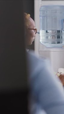 Vertical video: African american woman using video call telework on computer, attending business meeting with colleagues on webcam. Young adult talking to agency employees on online videoconference.