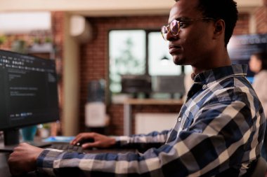 Software developers working with html script on terminal window, looking at computer screen and typing. IT system engineer writing ai algorithm and sitting at desk in it startup company.