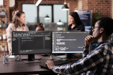 Tech engineer programming server code algorithm on computer, typing sever data in it agency office. Software developer working on new user interface with online system to create algorithm.
