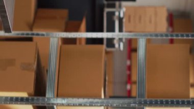 Vertical video: Empty storehouse space filled with multiple goods, storage room with carton packages on shelves. Stock merchandise placed on racks in warehouse, supply chain distribution management.
