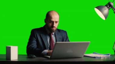 Concerned person making mistake over greenscreen, feeling angry about business fail. Corporate employee working under pressure on isolated mockup copyspace, blank chroma key background.