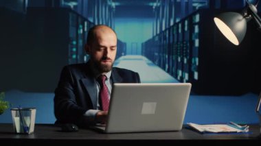 System administrator working in data center render farm, creating cloud computing service for innovation and digitalization. Database admin using big hardware data in server room.