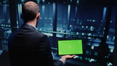 IT administrator running greenscreen display on tablet, using cloud computing in render farm. System technician working with isolated template and chroma key copyspace, artificial intelligence.