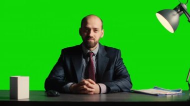 POV of manager talking on videocall over greenscreen, sitting at desk on chroma key template. Young leader using remote videoconference with isolated mockup and copyspace backdrop.