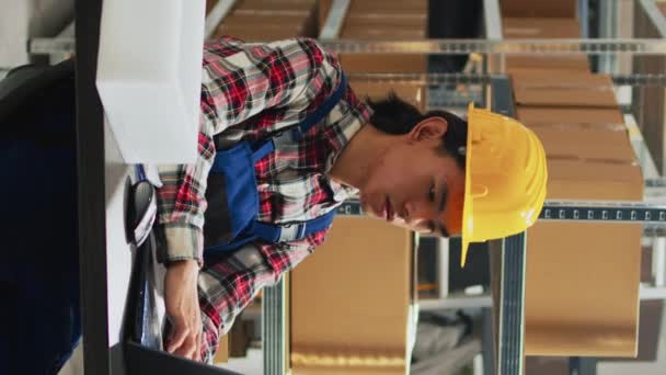 Vertical Video Asian Man Planning Shipment Orders Storage Room Working — Vídeo de stock