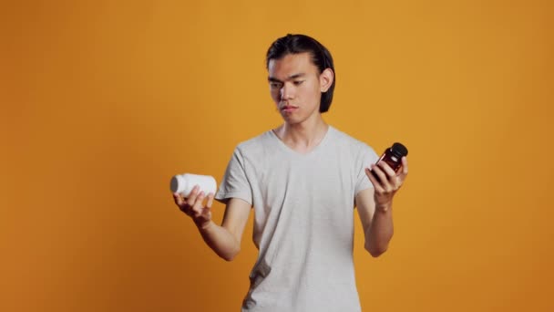 Young Man Being Clueless Bottles Pills Knowing How Take Medicine — Video Stock