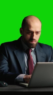 Vertical video: Concerned person making mistake over greenscreen, feeling angry about business fail. Corporate employee working under pressure on isolated mockup copyspace, blank chroma key background