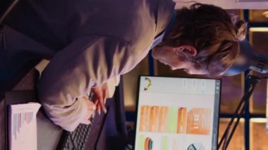 Vertical video: Furious stressed employee working on business project overtime, trying to finish financial report with analytics before deadline. Entrepreneur feeling frustrated under pressure