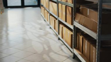 Storehouse supplies with cardboard boxes on racks, packages and carton containers prepared for products distribution and shipment. Warehouse room with retail store cargo, industrial stock.