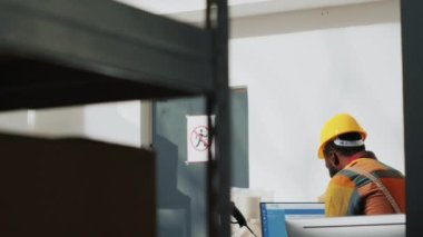 Team of workers bumping fists before finishing shipment, organizing manufacturing supplies in warehouse. Storage room employees doing fistbump after checking products carton boxes.