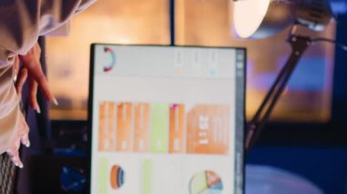 Vertical video: Focused woman planning financial investment charts, typing business profit or growth on pc. Female assistant analyzing diagrams for official report, checking progress in corporate
