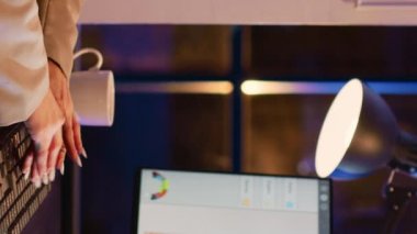 Vertical video: Female worker analyzing financial investment graphs, typing corporate profit or growth on computer. Young businesswoman working on data analytics for management report in corporate