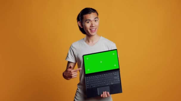 Cheerful Man Holding Laptop Greenscreen Camera Showing Isolated Display Template — Stockvideo