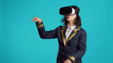 Stewardess using vr headset with interactive vision, having fun with virtual reality glasses. Cheerful air hostess dressed in flying uniform using 3d innovative goggles, professional airliner.