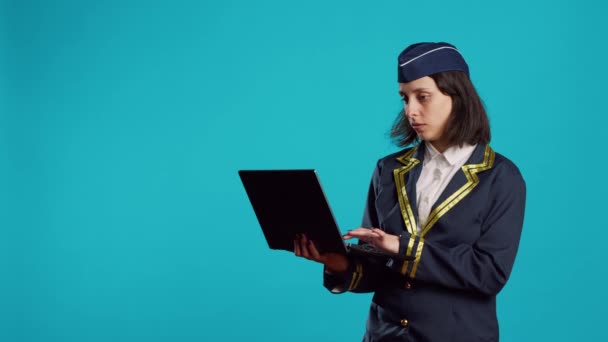 Young Female Airliner Using Laptop Studio Browsing Online Internet Page — Stockvideo