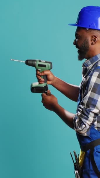 Vertical Video Male Builder Using Power Drill Instrument Wall Drilling — Video
