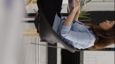 Vertical video: Business woman checking investment plan on computer, looking at annual data report for creative solution to increase profit. Young employee planning development with analytics