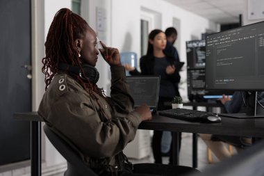 Web developer brainstorming programming ideas trying to write code and create new interface in office. Engineer working at server database in busy artificial intelligence developing agency.