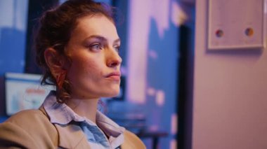 Executive manager brainstorming ideas in office at night and working late on marketing project before deadline. Young woman with corporate job planning financial diagrams report. Handheld shot.